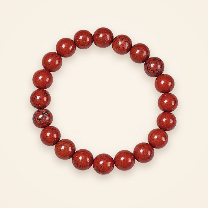 Red Jasper Bracelet, top view on an ivory background