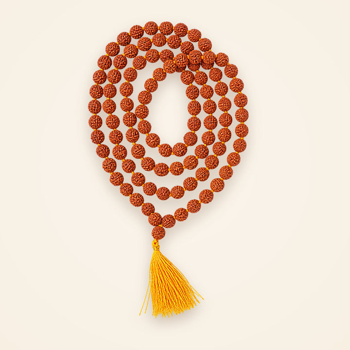 Siddh 5 Mukhi Rudraksha jaap mala of 108 beads with saffron tassel, laid in a circle