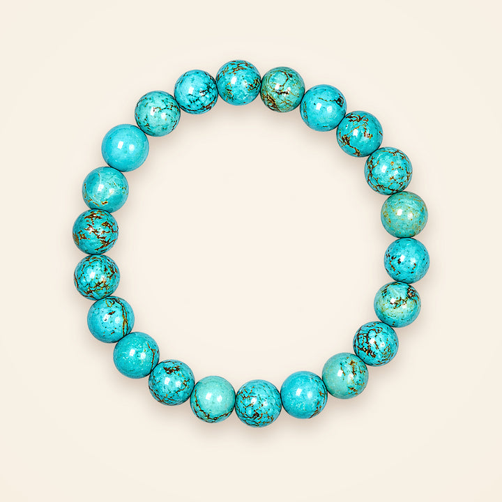 Turquoise (Firoza) Bracelet, top view on an ivory background